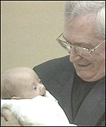 Cardinal Winning with baby