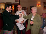 Peter Wright supervising raffle draw under Tom Preston's watchful eye