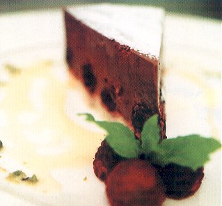 Chocolate truffle gateau with black cherries and white chocolate sauce