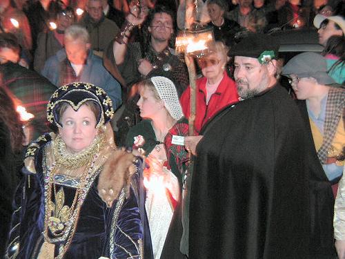 The Queen and her subjects arrive at the Church by candlelight to receive the blessing