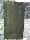 Graveslab of Gilbert De Greenlaw in Kinkell Church (near Inverurie).  he was killed at the Battle of Harlaw in 1411, but the gravestone had been economically re-used in 1592, possibly by a Forbes. 
