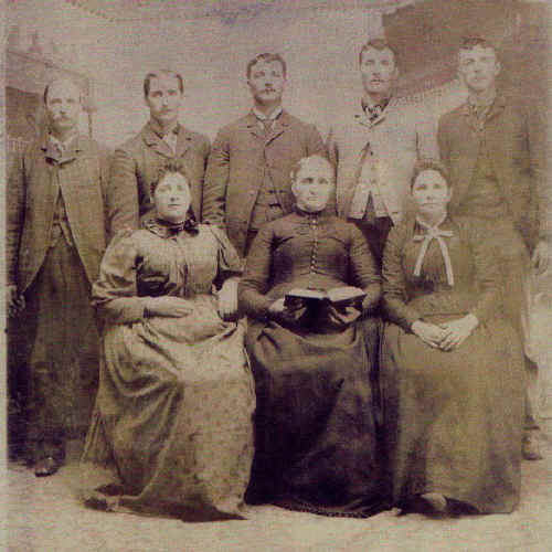 Miranda Clark Brewer holds the family Bible here in the center of the picture.